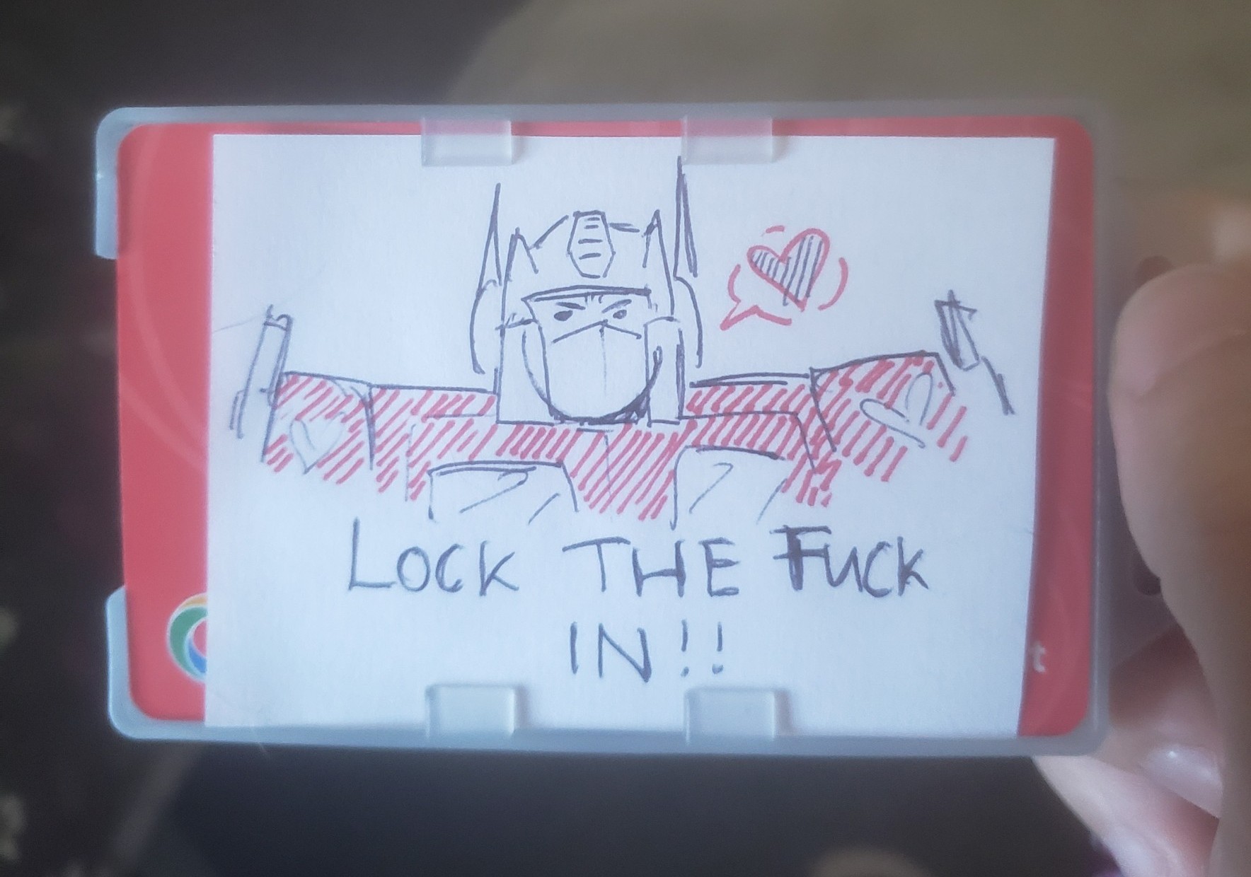 A doodle of Optimus Prime looking stern. Below him is written 'LOCK THE FUCK IN'